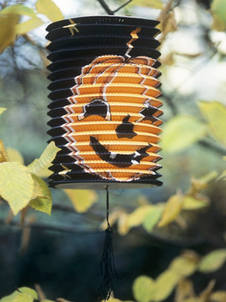 Paper Lantern with Printed Pumpkin Face Hanging in Tree