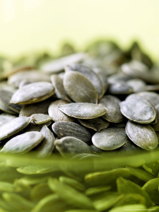 Pumpkin Seeds, Close-up of Seeds in a Green Glass Bowl