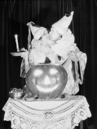 Couple Kissing By Pumpkin Jack-O-Lantern Candle Light