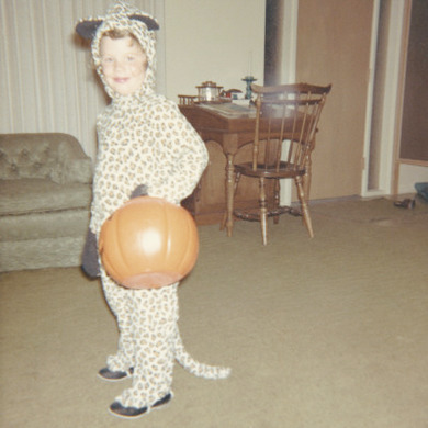 Retro Photograph of a Young Girl in Trick or Treat Fancy Dress, Carrying a Pumpkin